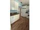 White cabinets and wood-look flooring in this kitchen with a full appliance suite at 30965 E Thyme Ave, Eustis, FL 32736