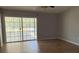 Living room with hardwood floors and glass sliding doors at 30965 E Thyme Ave, Eustis, FL 32736
