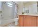 Clean bathroom with white tiles, shower-tub combo, vanity with marble countertops, and neutral decor at 33919 Terragona Dr, Sorrento, FL 32776
