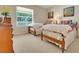 Spacious bedroom featuring twin beds and natural light from the window and dresser at 33919 Terragona Dr, Sorrento, FL 32776