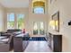 Bright foyer with soaring ceilings, decorative glass doors, and a view into the living spaces at 33919 Terragona Dr, Sorrento, FL 32776
