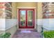 Elegant double front doors with glass inlays and stone accents, inviting entry to the home at 33919 Terragona Dr, Sorrento, FL 32776