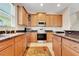 Well-lit kitchen featuring granite countertops, stainless steel appliances, and ample cabinet space at 33919 Terragona Dr, Sorrento, FL 32776