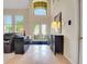Bright living room with soaring ceilings, tile floors, and statement decor at 33919 Terragona Dr, Sorrento, FL 32776