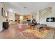 Open-concept living room and kitchen area featuring a staircase, modern furniture, and hardwood flooring at 33919 Terragona Dr, Sorrento, FL 32776