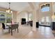 Open-concept living room featuring tiled floors, neutral walls, and lots of natural light from large windows at 33919 Terragona Dr, Sorrento, FL 32776