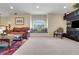 Cozy living room with a window seat, plush carpet, and stylish decor at 33919 Terragona Dr, Sorrento, FL 32776