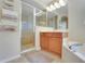 This main bathroom features a walk-in shower, soaking tub, and ample counter space for added convenience at 33919 Terragona Dr, Sorrento, FL 32776