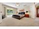 This bedroom has a large bed, with access to the outdoor balcony, and an ensuite bathroom for added privacy at 33919 Terragona Dr, Sorrento, FL 32776