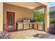 Outdoor grilling area featuring a built-in grill, stainless steel cabinetry and covered patio at 33919 Terragona Dr, Sorrento, FL 32776