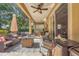 Covered outdoor patio with comfortable seating, a ceiling fan, and a view of the backyard at 33919 Terragona Dr, Sorrento, FL 32776