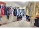 This walk-in closet offers plenty of storage space, with built-in shelving and hanging rods for organization at 33919 Terragona Dr, Sorrento, FL 32776