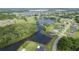 Stunning aerial view showcases community's lush greenery, tranquil lake, and neighborhood layout at 3600 Fountainbleu Blvd, Kissimmee, FL 34746
