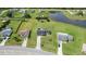 Expansive aerial view of the property, showcasing its large lot, landscaping, and proximity to a pond at 3600 Fountainbleu Blvd, Kissimmee, FL 34746