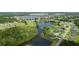Spectacular aerial view showcasing community’s lush greenery, tranquil lake, and neighborhood layout at 3600 Fountainbleu Blvd, Kissimmee, FL 34746