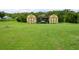 The expansive backyard of the property has several sheds perfect for storage and green lawn at 3600 Fountainbleu Blvd, Kissimmee, FL 34746