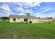 Lush backyard with a well-maintained lawn, offering ample space and privacy in a serene setting at 3600 Fountainbleu Blvd, Kissimmee, FL 34746