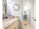 This charming bathroom features a marble vanity top, and ample lighting with an attached shower at 3600 Fountainbleu Blvd, Kissimmee, FL 34746