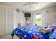 A well-lit bedroom features playful decor, including a dinosaur-themed bedspread and playful storage at 3600 Fountainbleu Blvd, Kissimmee, FL 34746