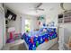 A well-lit bedroom features playful decor, including a dinosaur-themed bedspread and playful storage at 3600 Fountainbleu Blvd, Kissimmee, FL 34746