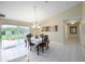 Cozy dining room with tiled floors, modern lighting fixture, and backyard view at 3600 Fountainbleu Blvd, Kissimmee, FL 34746
