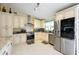 Well-lit kitchen featuring stainless steel appliances, white cabinetry, and tile flooring at 3600 Fountainbleu Blvd, Kissimmee, FL 34746