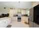 Bright kitchen with stainless steel appliances, white cabinetry, and light countertops at 3600 Fountainbleu Blvd, Kissimmee, FL 34746