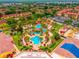 Aerial view of a community pool, lush landscaping, and colorful umbrellas at 3725 Calabria Ave, Davenport, FL 33897