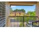 View from a balcony with black railings overlooking landscaped grounds and a building exterior at 3725 Calabria Ave, Davenport, FL 33897