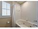 A bright bathroom featuring a jacuzzi tub and white tile at 3725 Calabria Ave, Davenport, FL 33897