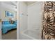 Bathroom area with shower-tub combination, surrounded by a bedroom view at 3725 Calabria Ave, Davenport, FL 33897