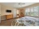 Bedroom with ceiling fan, flat screen TV, and access to an ensuite bathroom at 3725 Calabria Ave, Davenport, FL 33897