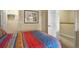 Bedroom with a colorful bedspread and a hallway leading to more rooms at 3725 Calabria Ave, Davenport, FL 33897