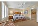 Comfortable bedroom with ceiling fan, side tables, and bright windows for ample natural light at 3725 Calabria Ave, Davenport, FL 33897