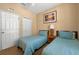 Comfortable bedroom featuring two twin beds, shuttered window, neutral walls, and closet at 3725 Calabria Ave, Davenport, FL 33897