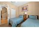 Comfortable bedroom featuring two twin beds, shuttered window, neutral walls, closet, and entryway at 3725 Calabria Ave, Davenport, FL 33897