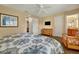 A bedroom with a ceiling fan, dresser, and access to a bathroom with wood cabinets at 3725 Calabria Ave, Davenport, FL 33897