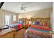 Bedroom featuring two beds with tropical bedding, a shared bedside table, and a ceiling fan at 3725 Calabria Ave, Davenport, FL 33897