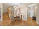 Dining room features a hardwood floor, dining table with a chandelier, and wooden staircase at 3725 Calabria Ave, Davenport, FL 33897