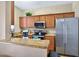 Modern kitchen featuring granite countertops, stainless steel appliances, and wooden cabinetry at 3725 Calabria Ave, Davenport, FL 33897