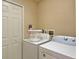 Compact laundry room with stacked washer and dryer, and a utility sink at 3725 Calabria Ave, Davenport, FL 33897