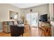 Inviting living room with hardwood floors, seating, and sliding glass doors for natural light at 3725 Calabria Ave, Davenport, FL 33897