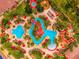 Aerial view of a community pool featuring winding walkways, palm trees, and lounge chairs at 3725 Calabria Ave, Davenport, FL 33897