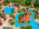 Aerial view of a community pool featuring winding walkways, palm trees, and lounge chairs at 3725 Calabria Ave, Davenport, FL 33897