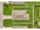 Aerial view of a single-story home featuring a well-maintained lawn and white vinyl fence at 391 Begonia Ct, Kissimmee, FL 34759