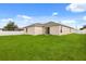 Expansive backyard with lush green grass and a white fence, perfect for outdoor activities at 391 Begonia Ct, Kissimmee, FL 34759