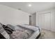 A bedroom with a bed, a patterned comforter, and a gray rug at 391 Begonia Ct, Kissimmee, FL 34759