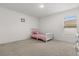 A bedroom featuring a small bed, a window, and a carpeted floor at 391 Begonia Ct, Kissimmee, FL 34759