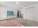 A bedroom with a dresser, closet, TV, and pink unicorn bedding at 391 Begonia Ct, Kissimmee, FL 34759