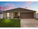 Inviting single-story home featuring a neatly manicured lawn and an attached two-car garage at 391 Begonia Ct, Kissimmee, FL 34759